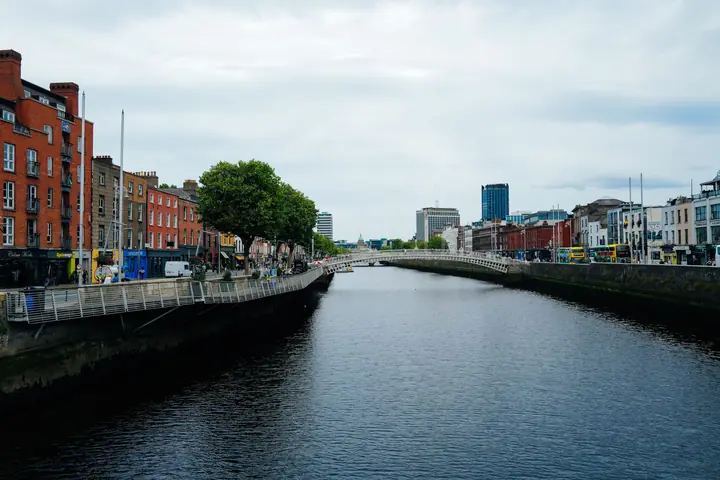 River Liffey and the Ha'penny Bridge with riverside buildings in Dublin, Ireland