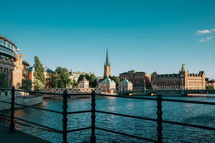 Riddarholm Church spire and the Norstedts building on Riddarholmen, seen across the water in Stockholm, Sweden